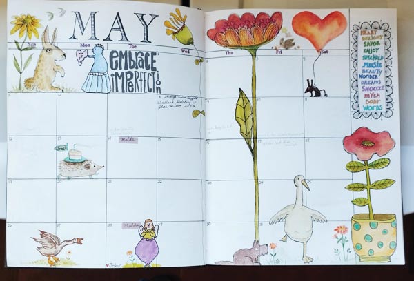 The month of May page in a calendar book with stamped and coloured flowers and animal throughout